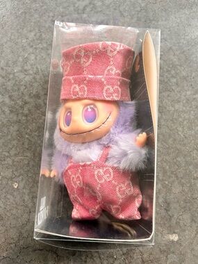 Plush Collectible Figure in Pink and Lavender - Branded Monogram Overalls